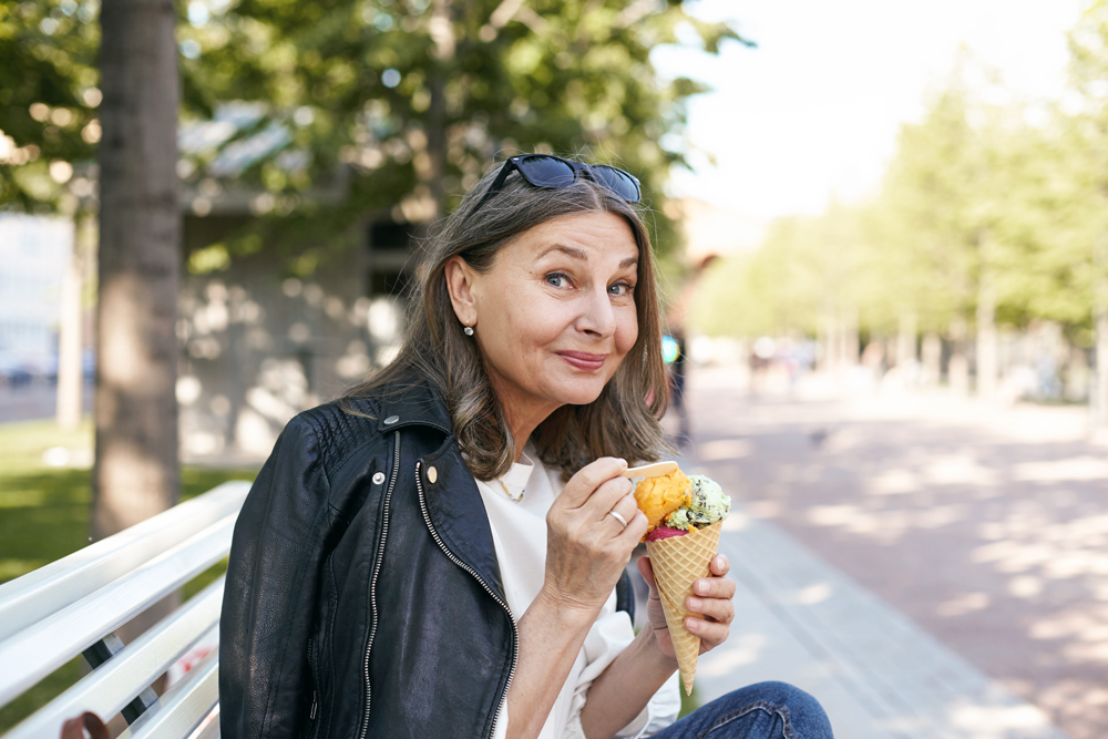 Mature woman enjoying ice cream, healthy teeth